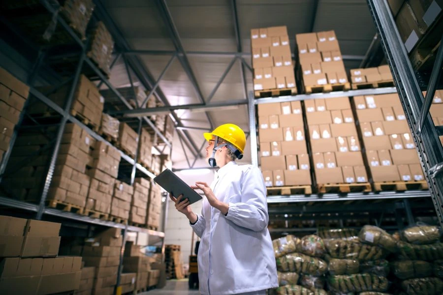 Person in warehouse looking at packages.